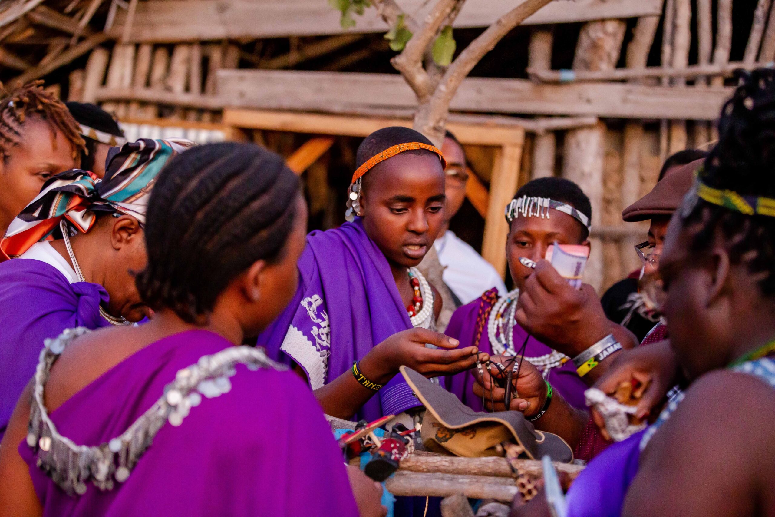 Maasai women in colorful attire engage in cultural activities in Mikumi, Tanzania.